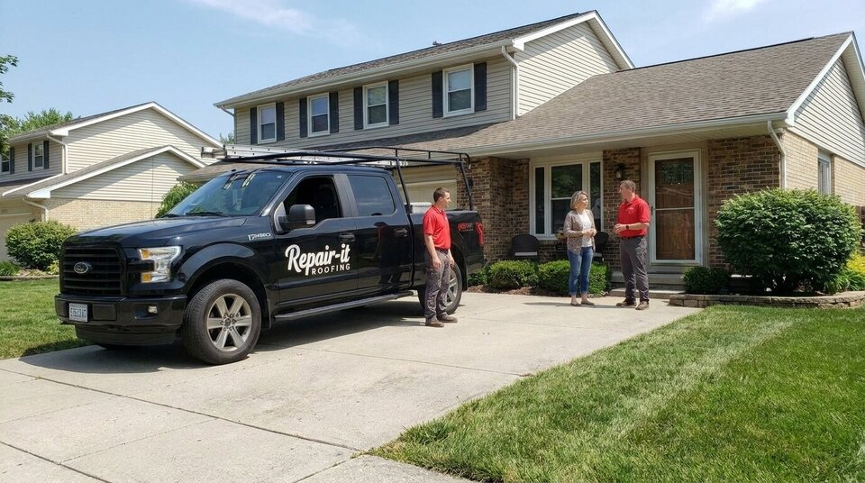 A company truck parked in a driveway during a visit.